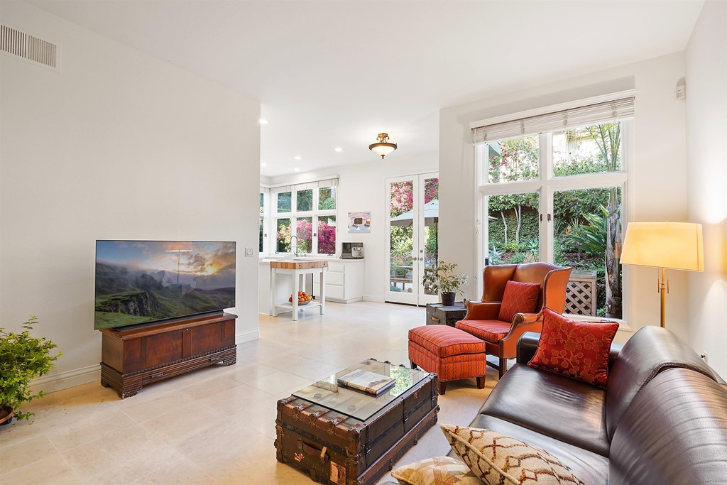 9735 Claiborne Square La Jolla, CA 92037 - Photo 20 of 60 a living room with furniture and a flat screen tv