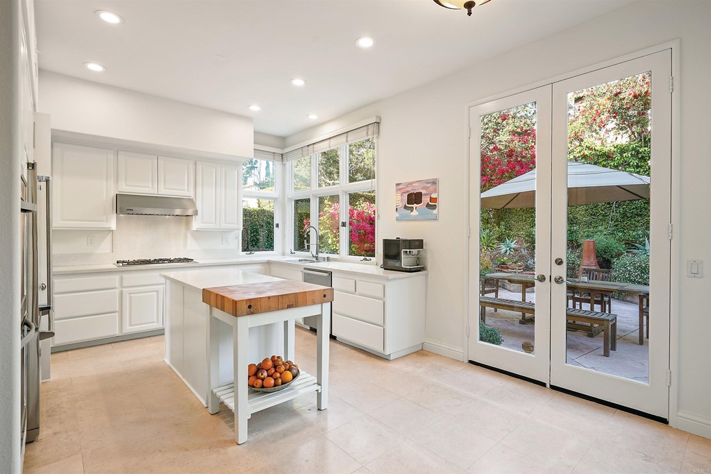 9735 Claiborne Square La Jolla, CA 92037 - Photo 21 of 60 a kitchen with a refrigerator and a stove