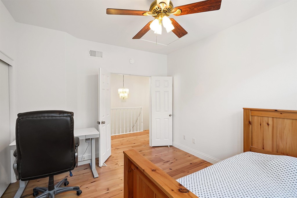 9735 Claiborne Square La Jolla, CA 92037 - Photo 44 of 60 a bedroom with a bed and a chair