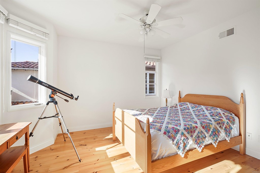 9735 Claiborne Square La Jolla, CA 92037 - Photo 47 of 60 a bedroom with a bed and a dresser