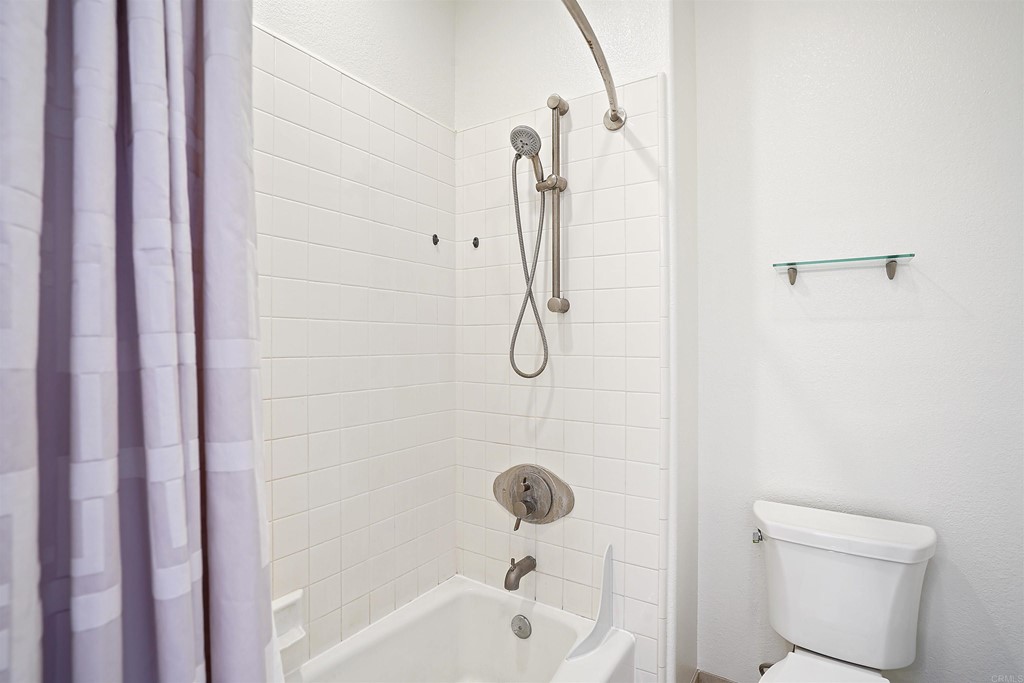 9735 Claiborne Square La Jolla, CA 92037 - Photo 50 of 60 a bathroom with a shower a toilet and a sink