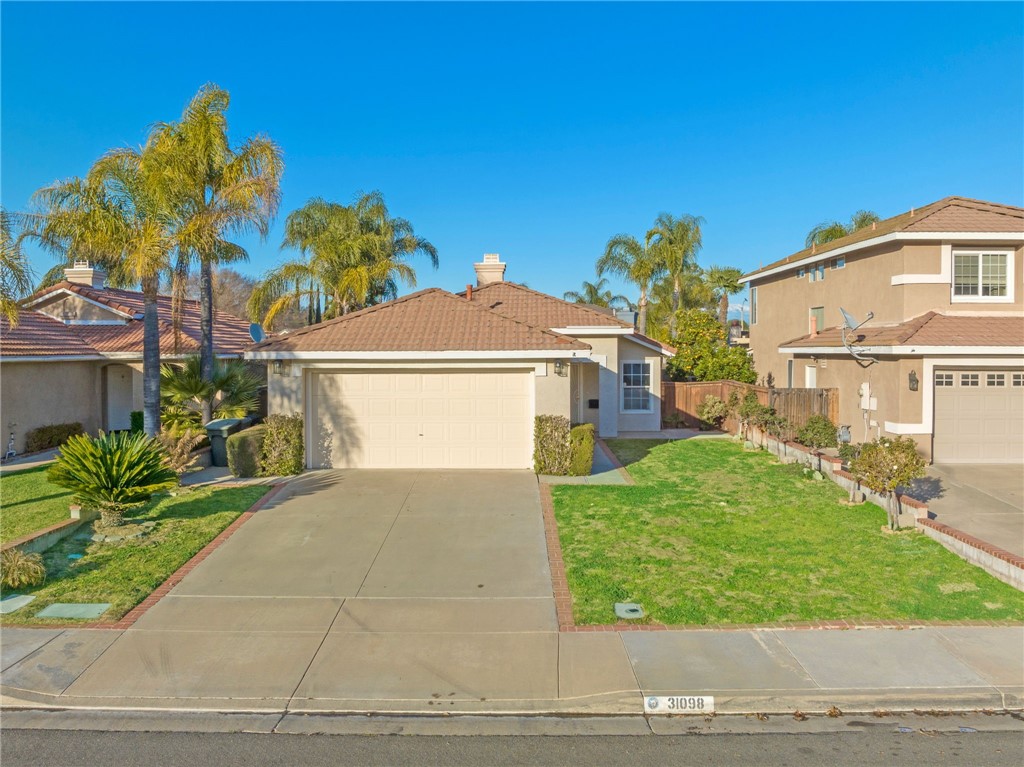 31098 Ruidosa Street Temecula, CA 92592 - Photo 1 of 1 a front view of a house with a yard and garage