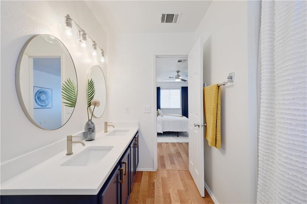 12329 Sky Harbor Drive Del Valle, TX 78617 - Photo 13 of 29 a bathroom with a sink and a mirror