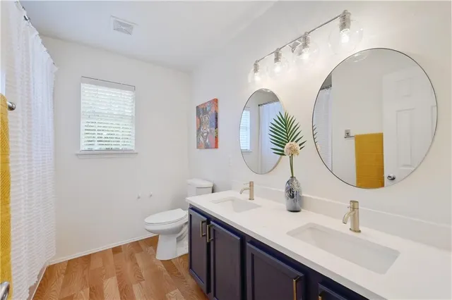 a bathroom with a double vanity sink and a mirror