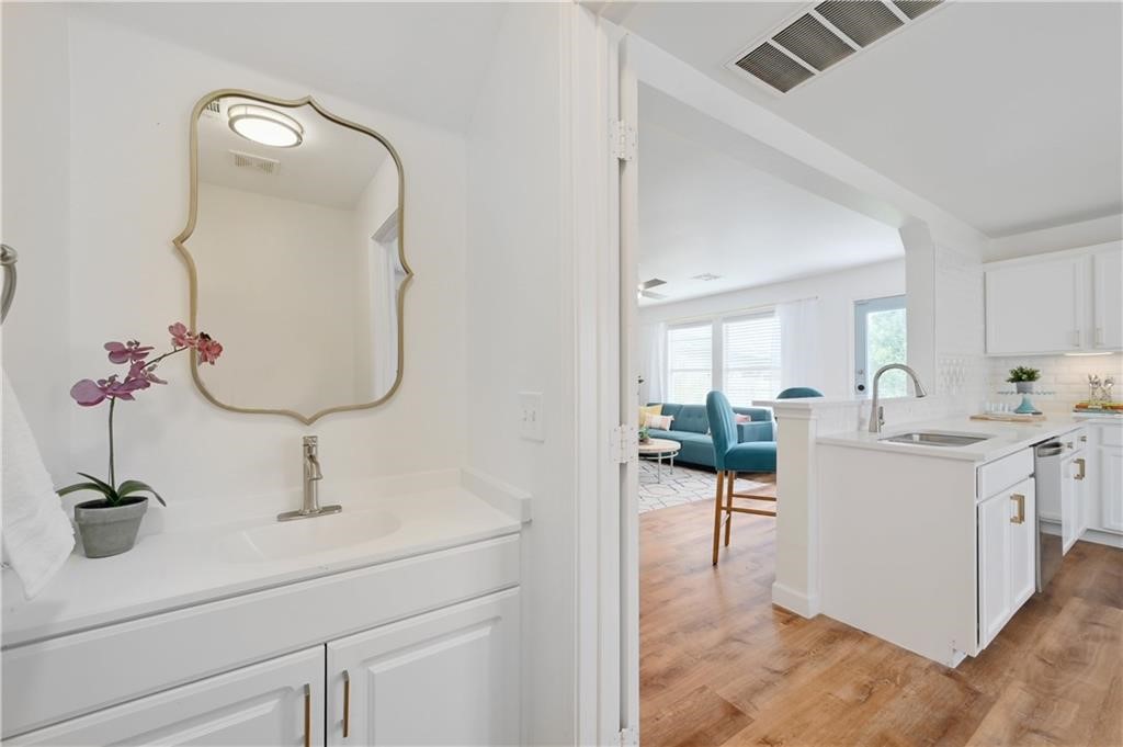12329 Sky Harbor Drive Del Valle, TX 78617 - Photo 16 of 29 a en suite bathroom with a double vanity sink and a mirror