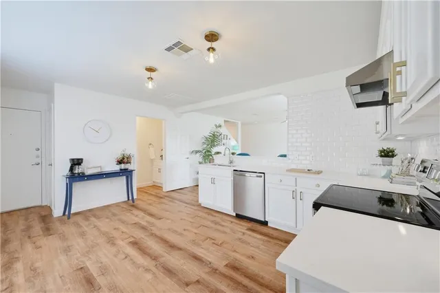 a kitchen with a sink appliances and cabinets