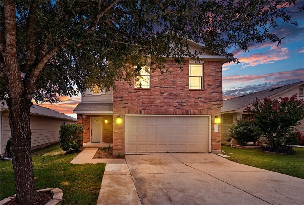 12329 Sky Harbor Drive Del Valle, TX 78617 - Photo 2 of 29 a front view of a house with garden
