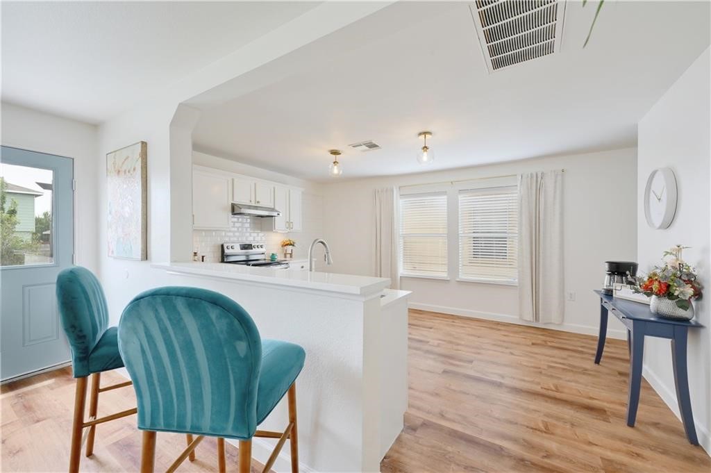 12329 Sky Harbor Drive Del Valle, TX 78617 - Photo 21 of 29 a living room with furniture and a wooden floor
