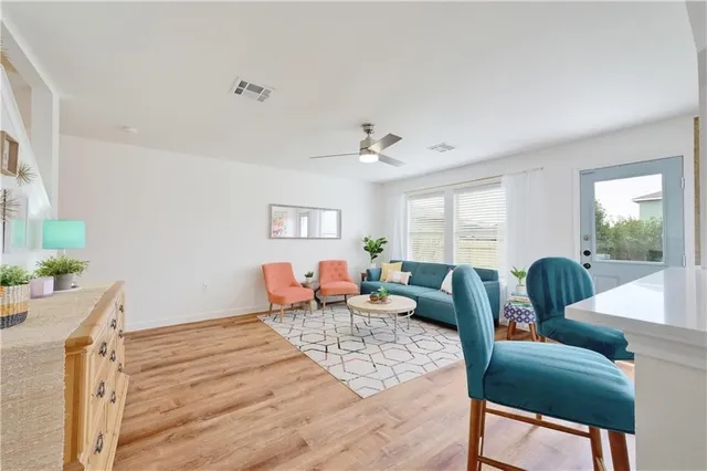 a living room with furniture and wooden floor