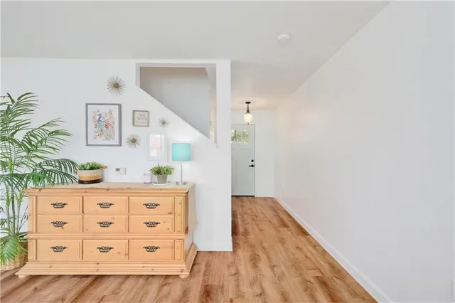 a view of hallway with wooden floor