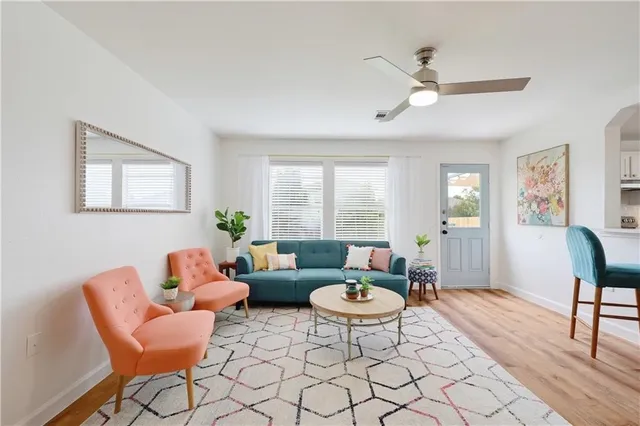 a living room with furniture a rug and a window