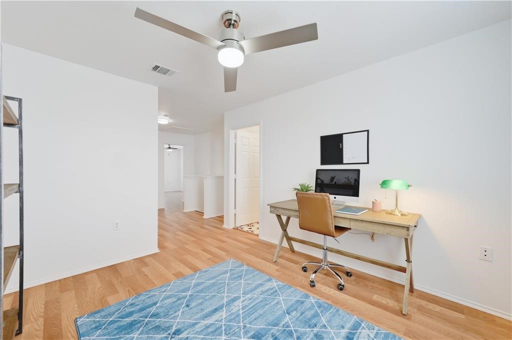 12329 Sky Harbor Drive Del Valle, TX 78617 - Photo 10 of 29 a room with furniture and a wooden floor