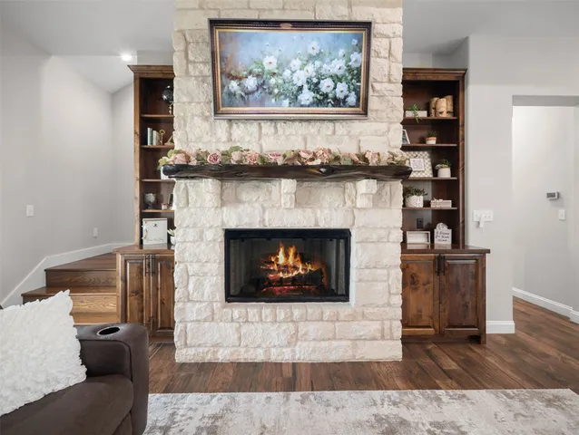 a kitchen with stainless steel appliances granite countertop a table chairs sink and cabinets