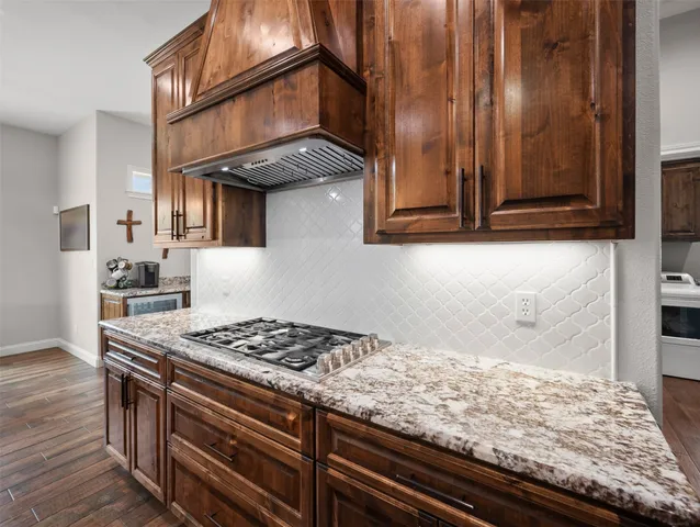 a bathroom with a granite countertop sink a mirror and shower