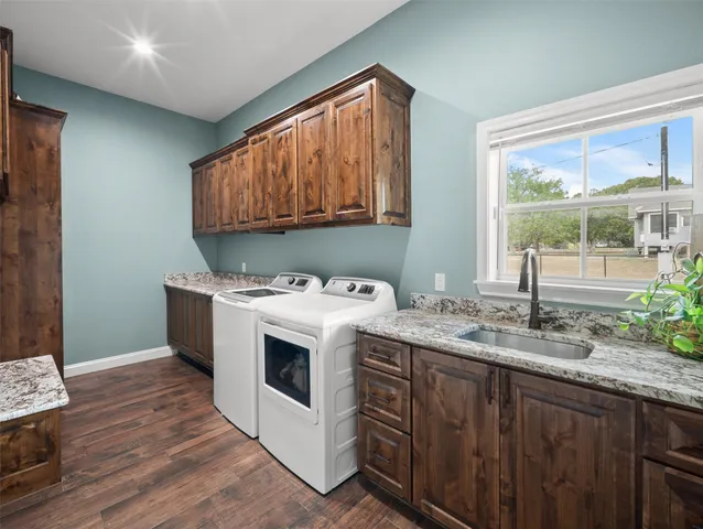a bathroom with a granite countertop toilet a sink and a mirror