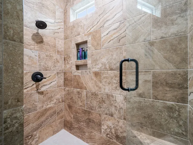 a view of a house with a yard and large tree