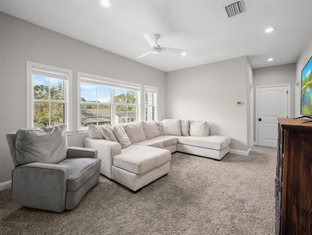 a view of a big yard with plants and large trees
