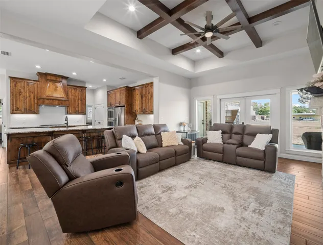 a view of a dining room with furniture a chandelier and wooden floor