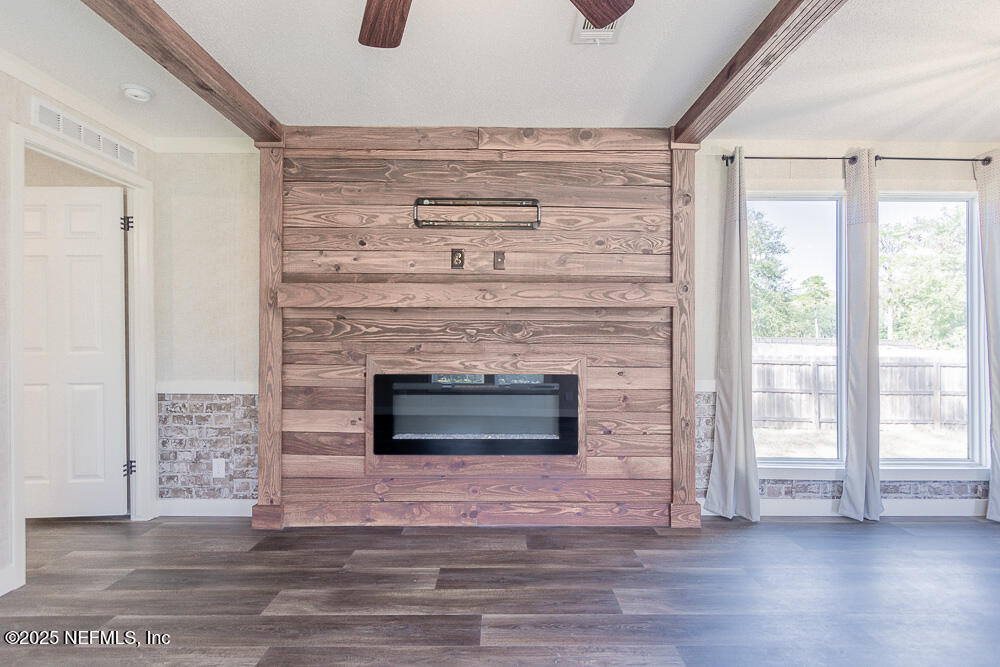 475 AJ Mills Road Ponte Vedra, FL 32081 - Photo 12 of 34 a living room with a fireplace and a floor to ceiling window