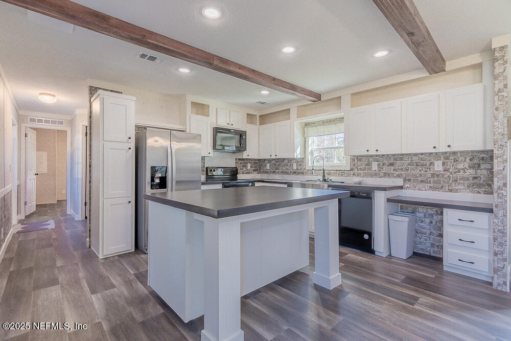 475 AJ Mills Road Ponte Vedra, FL 32081 - Photo 13 of 34 a kitchen with stainless steel appliances granite countertop a sink stove refrigerator and cabinets