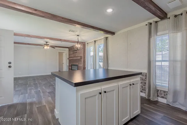 a kitchen with white cabinets a sink and dishwasher