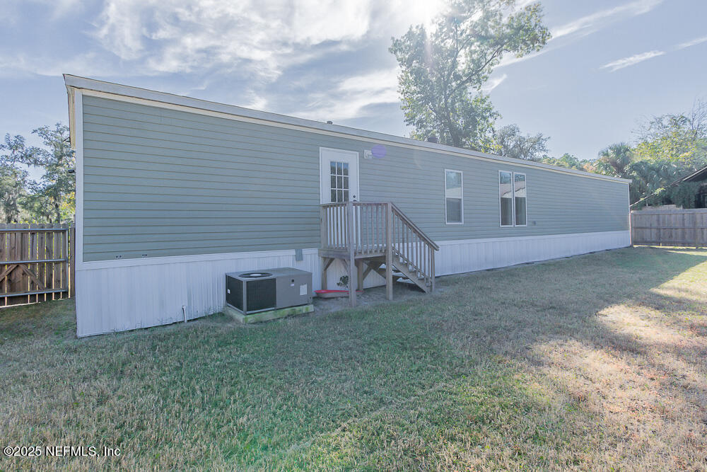 475 AJ Mills Road Ponte Vedra, FL 32081 - Photo 32 of 34 a backyard of a house with table and chairs