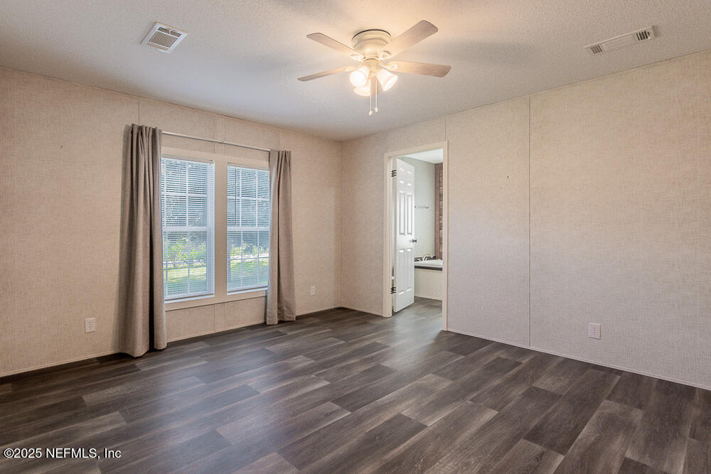 475 AJ Mills Road Ponte Vedra, FL 32081 - Photo 4 of 34 an empty room with wooden floor and windows