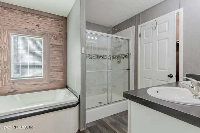a bathroom with a granite countertop sink a toilet and shower