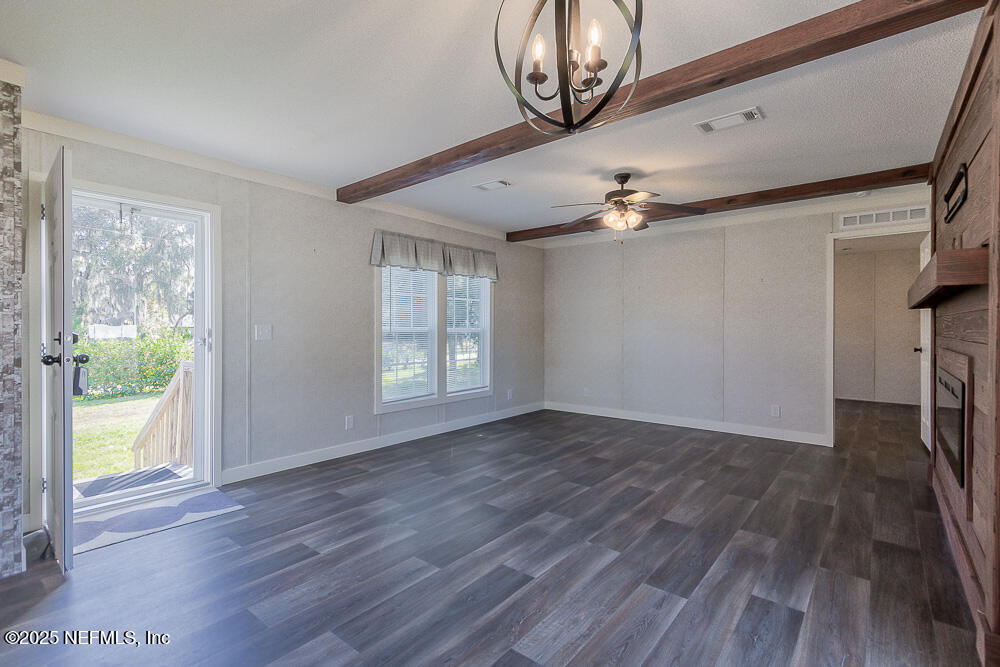 475 AJ Mills Road Ponte Vedra, FL 32081 - Photo 9 of 34 a view of an empty room with wooden floor and a window