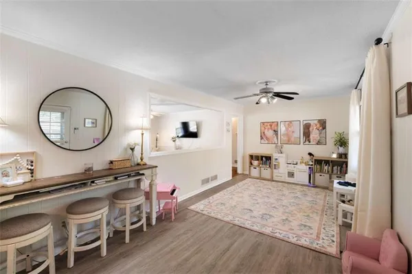 a living room with furniture a mirror and a table