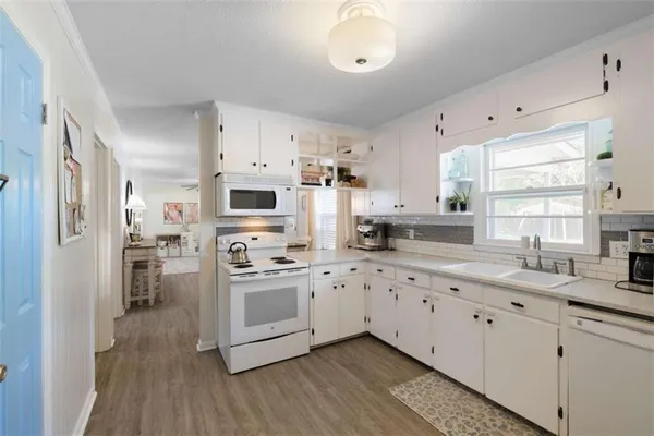 a kitchen with cabinets a sink and stainless steel appliances