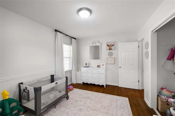a bedroom with furniture and a wooden floor