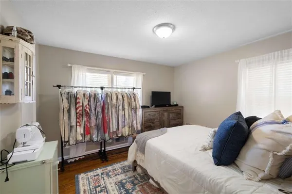 a bedroom with a bed and a television