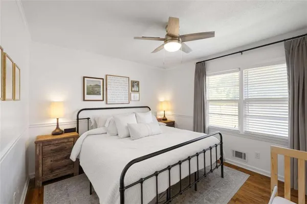 a bedroom with a bed a chandelier and a window