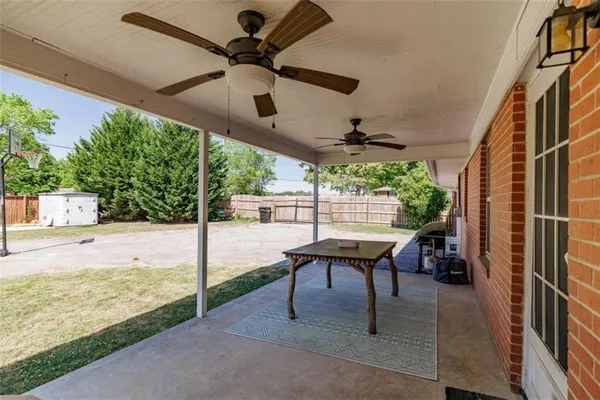 a view of a porch with furniture and a yard