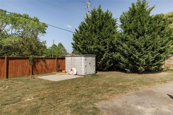 a backyard of a house with basket ball court