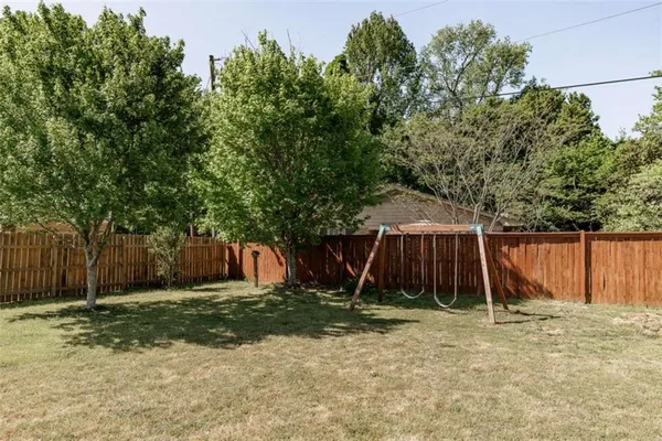 a view of backyard with small cabin