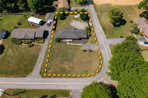 an aerial view of residential houses with outdoor space and swimming pool