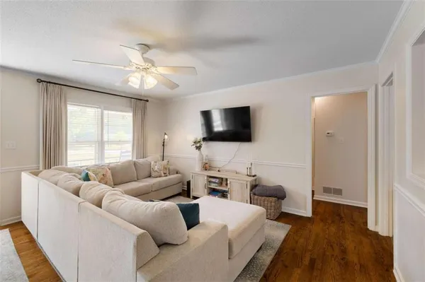 a living room with furniture and a flat screen tv