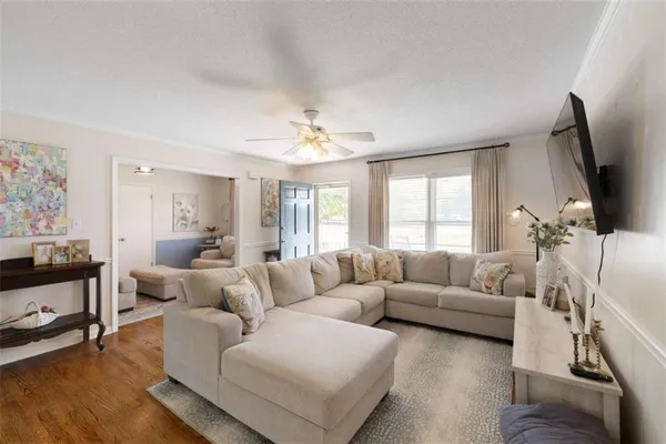 a living room with furniture and a flat screen tv