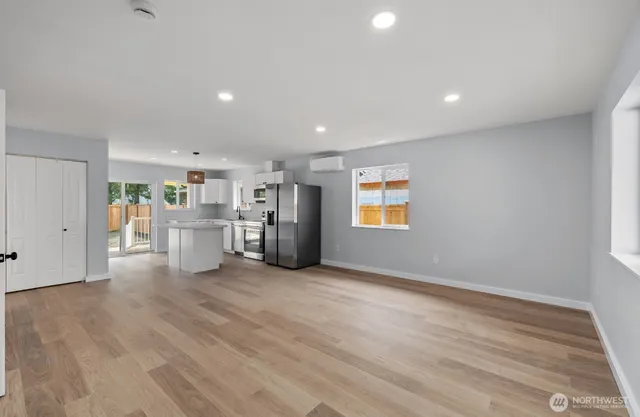 a view of a kitchen with a refrigerator a stove top oven