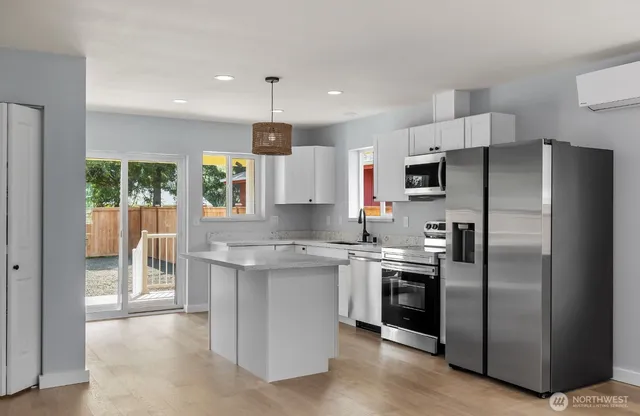 a kitchen with a sink stainless steel appliances and cabinets