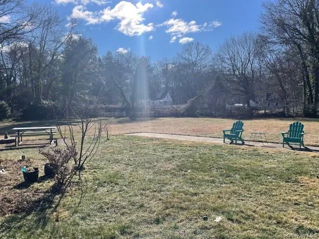 a view of a yard with table and chairs