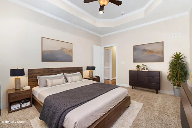 an empty room with chandelier fan and windows