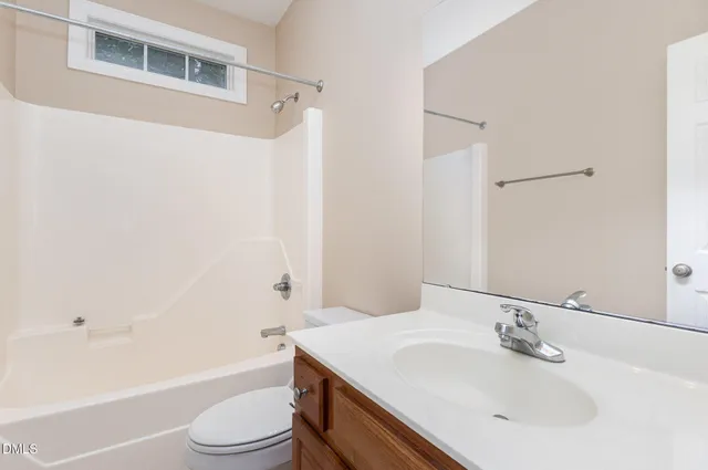 a utility room with granite countertop a sink