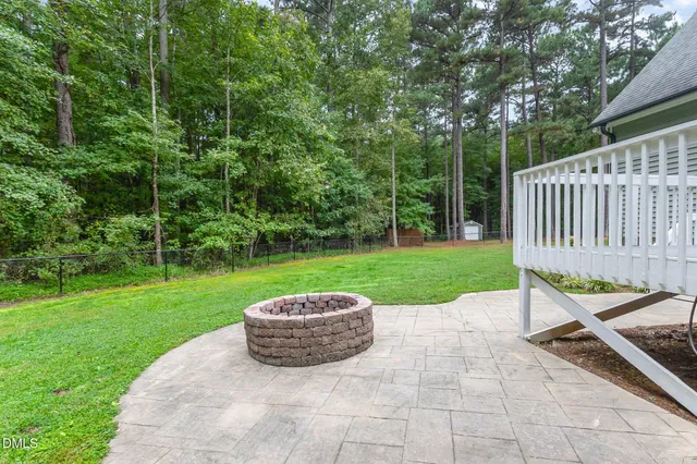 a view of a house with a swimming pool and a yard