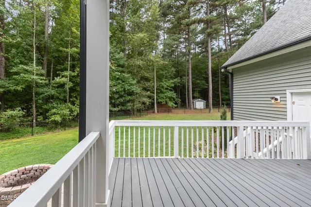 an aerial view of a house with a yard and lake view