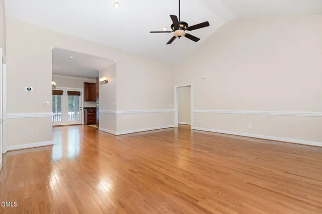 a living room with furniture a flat screen tv and a window