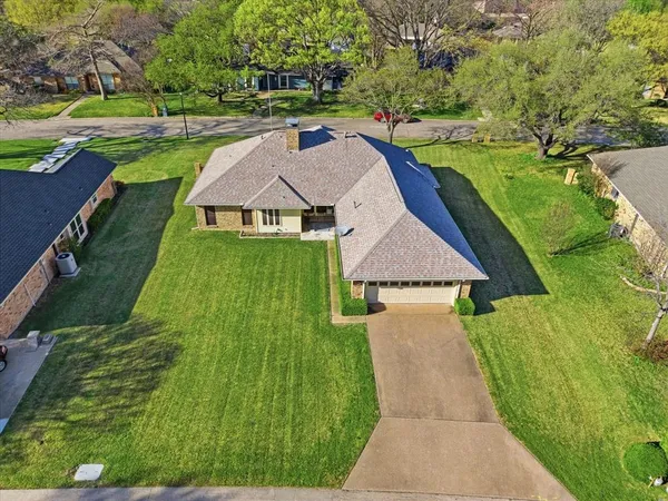 an aerial view of a house with yard swimming pool and outdoor seating