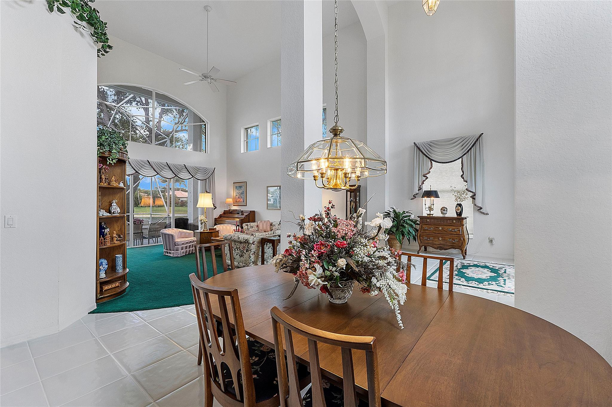 22293 Rushmore Place Boca Raton, FL 33428 - Photo 11 of 59 a view of a dining room and livingroom with furniture wooden floor a chandelier